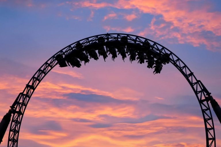 Roller coaster against sunset sky
